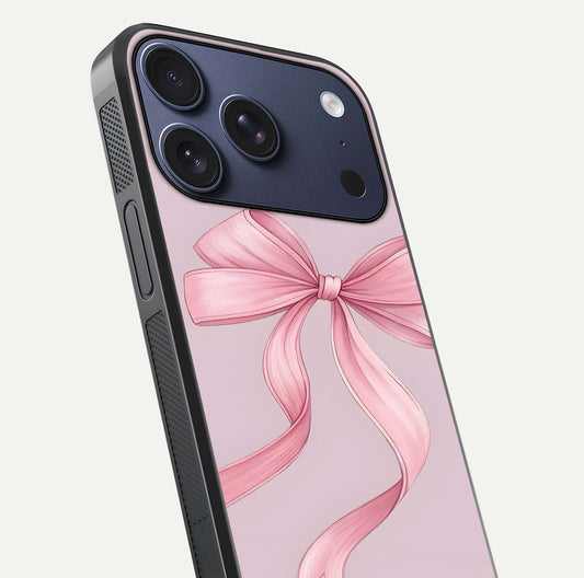 Soft Blush Bow iPhone 17 Pro glass phone case angled back view highlighting bow artwork and side grip texture