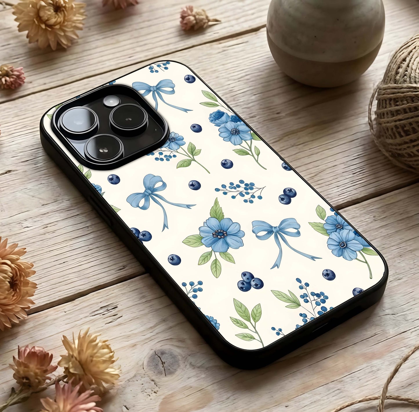 Blue Flower & Bow Glass Case photographed in natural light showing reflective finish and playful depth.