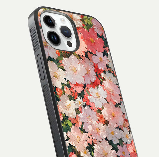 Blush Bloom Field Glass Case for iPhone 14 Pro close-up shot capturing pastel flower field tones and gloss shine