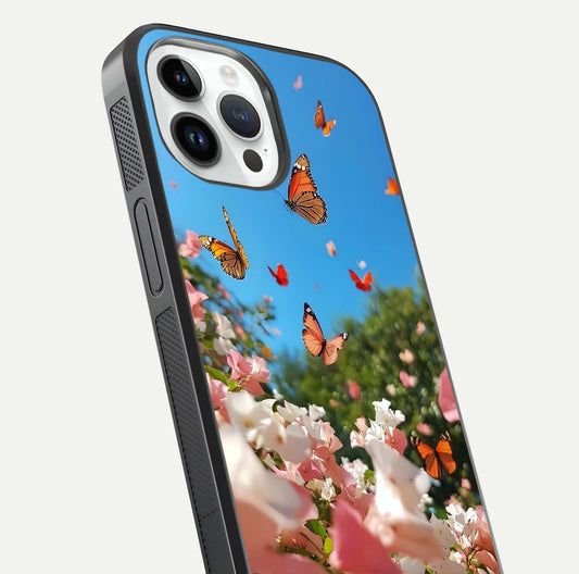 Butterflies in Bloom Sky Glass Case for iPhone 14 Pro close-up shot showing wings, petal reflections, and soft hues