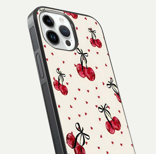 Cherry Heart Bow Glass Case for iPhone 14 Pro close-up highlighting small bows, cherry red tones, and gloss shine