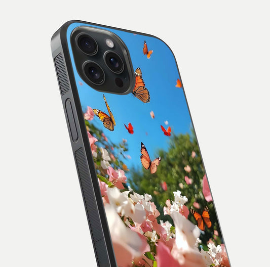 Butterflies in Bloom Sky Glass Case for iPhone 15 Pro close-up shot showing wings, petal reflections, and soft hues