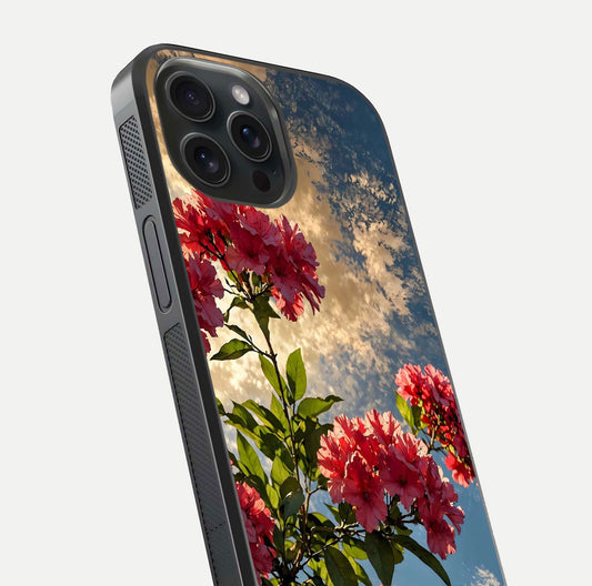 Red Bloom Skies Glass Case for iPhone 15 Pro close-up angled shot highlighting detailed blooms and reflection