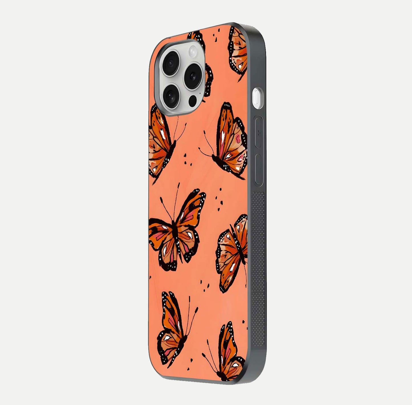 Coral Wing Butterfly Glass Case for iPhone 16 Pro side-angle photo showing reflective finish and smooth edges