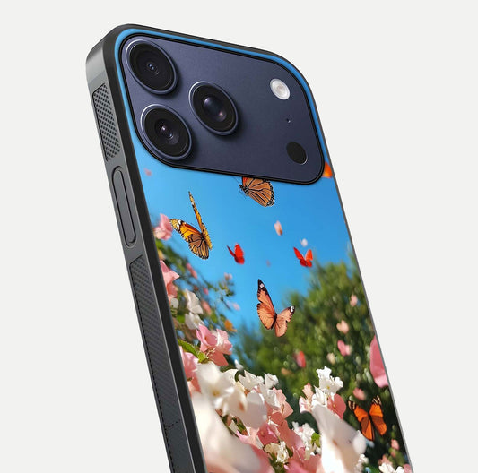 Butterflies in Bloom Sky Glass Case for iPhone 17 Pro close-up shot showing wings, petal reflections, and soft hues
