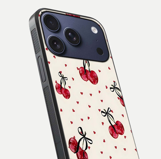 Cherry Heart Bow Glass Case for iPhone 17 Pro close-up highlighting small bows, cherry red tones, and gloss shine
