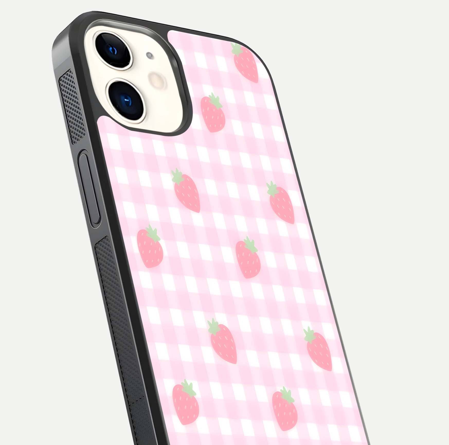 Strawberry Picnic Love iPhone 12 glass phone case angled back view highlighting strawberry illustrations and textured grip