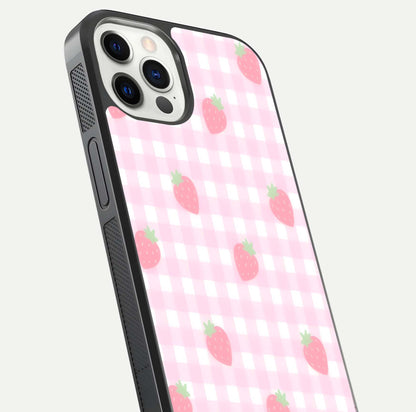 Strawberry Picnic Love iPhone 12 Pro glass phone case angled back view highlighting strawberry illustrations and textured grip