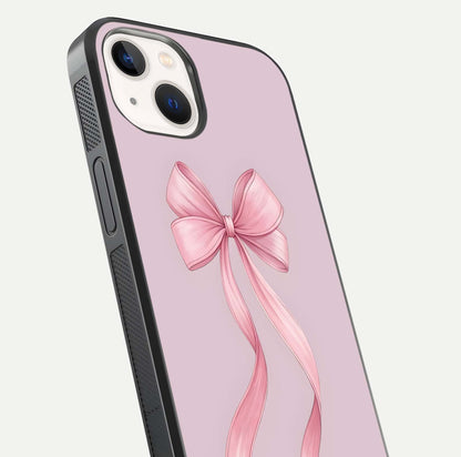Soft Blush Bow iPhone 14 glass phone case angled back view highlighting bow artwork and side grip texture