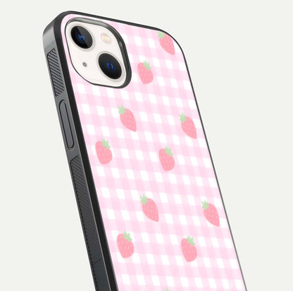 Strawberry Picnic Love iPhone 14 glass phone case angled back view highlighting strawberry illustrations and textured grip