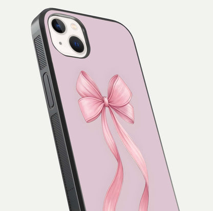 Soft Blush Bow iPhone 14 Plus glass phone case angled back view highlighting bow artwork and side grip texture