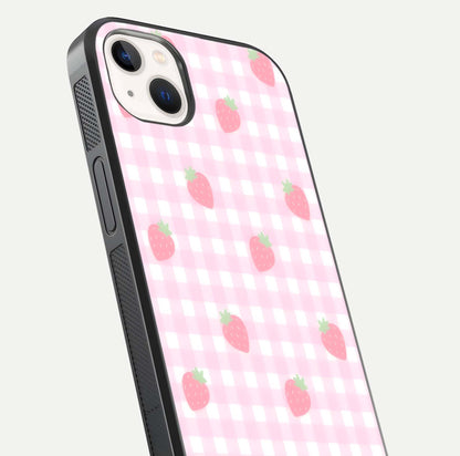 Strawberry Picnic Love iPhone 14 Plus glass phone case angled back view highlighting strawberry illustrations and textured grip