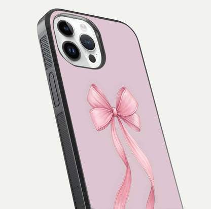 Soft Blush Bow iPhone 14 Pro glass phone case angled back view highlighting bow artwork and side grip texture