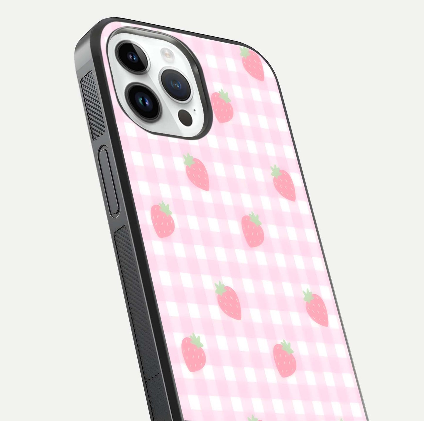 Strawberry Picnic Love iPhone 14 Pro glass phone case angled back view highlighting strawberry illustrations and textured grip