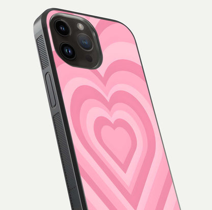 Blush Heart Waves iPhone 14 Pro Max glass phone case angled back view highlighting romantic heart wave artwork and grip texture