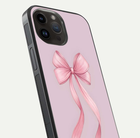 Soft Blush Bow iPhone 14 Pro Max glass phone case angled back view highlighting bow artwork and side grip texture