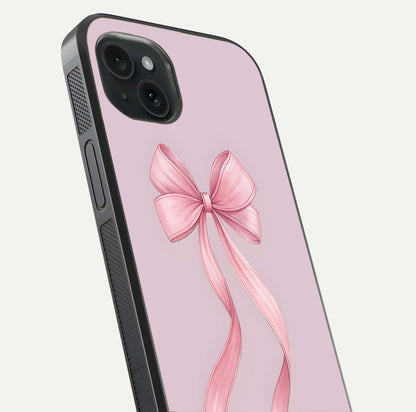 Soft Blush Bow iPhone 15 Plus glass phone case angled back view highlighting bow artwork and side grip texture