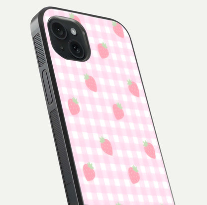 Strawberry Picnic Love iPhone 15 Plus glass phone case angled back view highlighting strawberry illustrations and textured grip