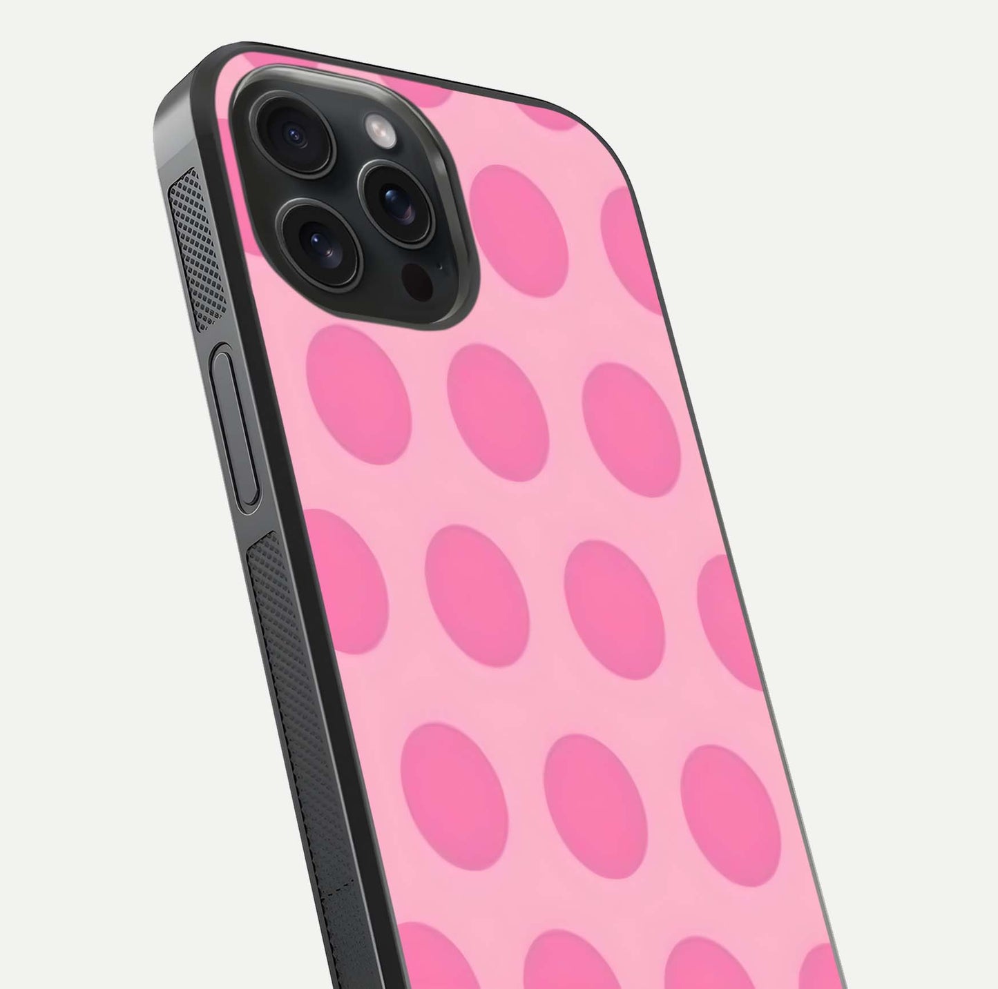Sweet Dot Dreams iPhone 15 Pro glass phone case angled back view highlighting dotted artwork and side grip texture