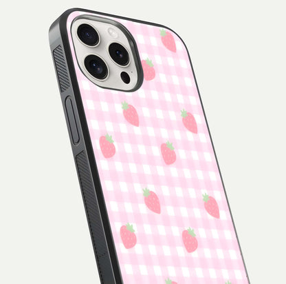 Strawberry Picnic Love iPhone 15 Pro Max glass phone case angled back view highlighting strawberry illustrations and textured grip