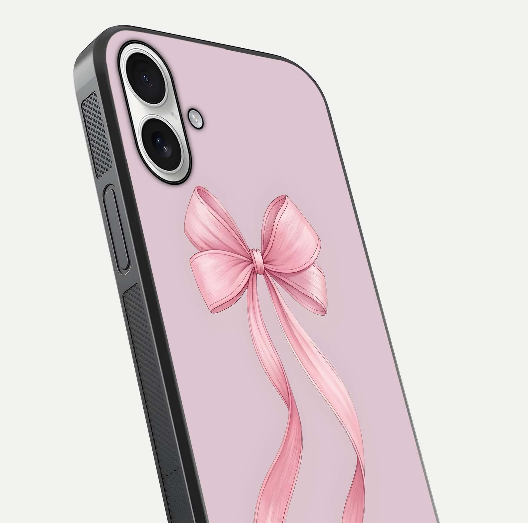Soft Blush Bow iPhone 17 glass phone case angled back view highlighting bow artwork and side grip texture