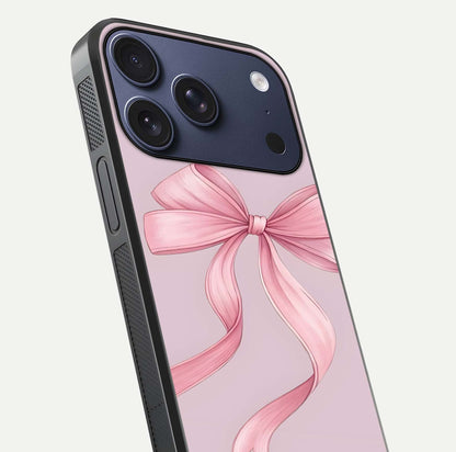 Soft Blush Bow iPhone 17 Pro glass phone case angled back view highlighting bow artwork and side grip texture