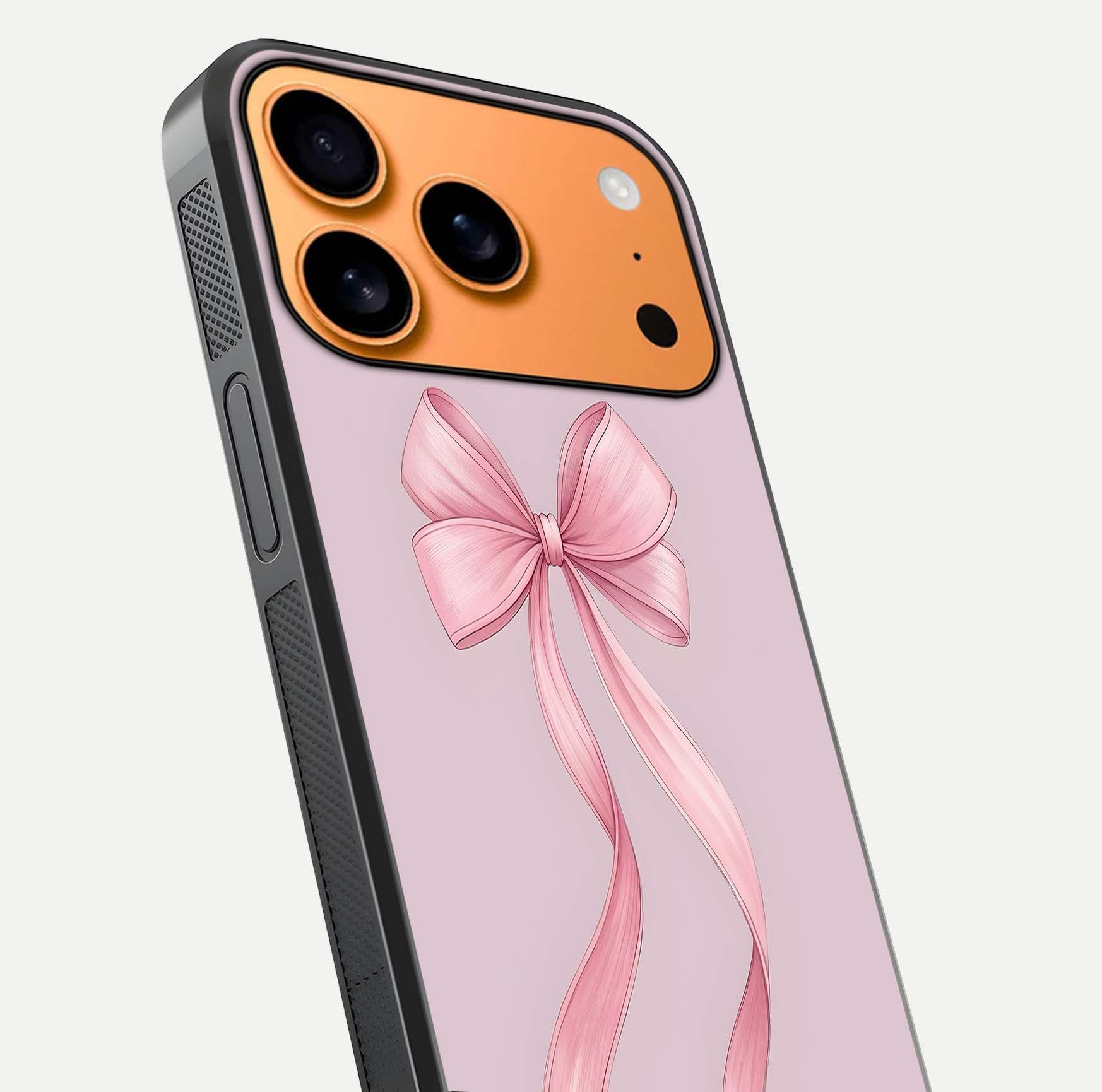 Soft Blush Bow iPhone 17 Pro Max glass phone case angled back view highlighting bow artwork and side grip texture