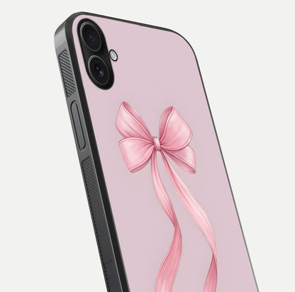 Soft Blush Bow iPhone 16 Plus glass phone case angled back view highlighting bow artwork and side grip texture