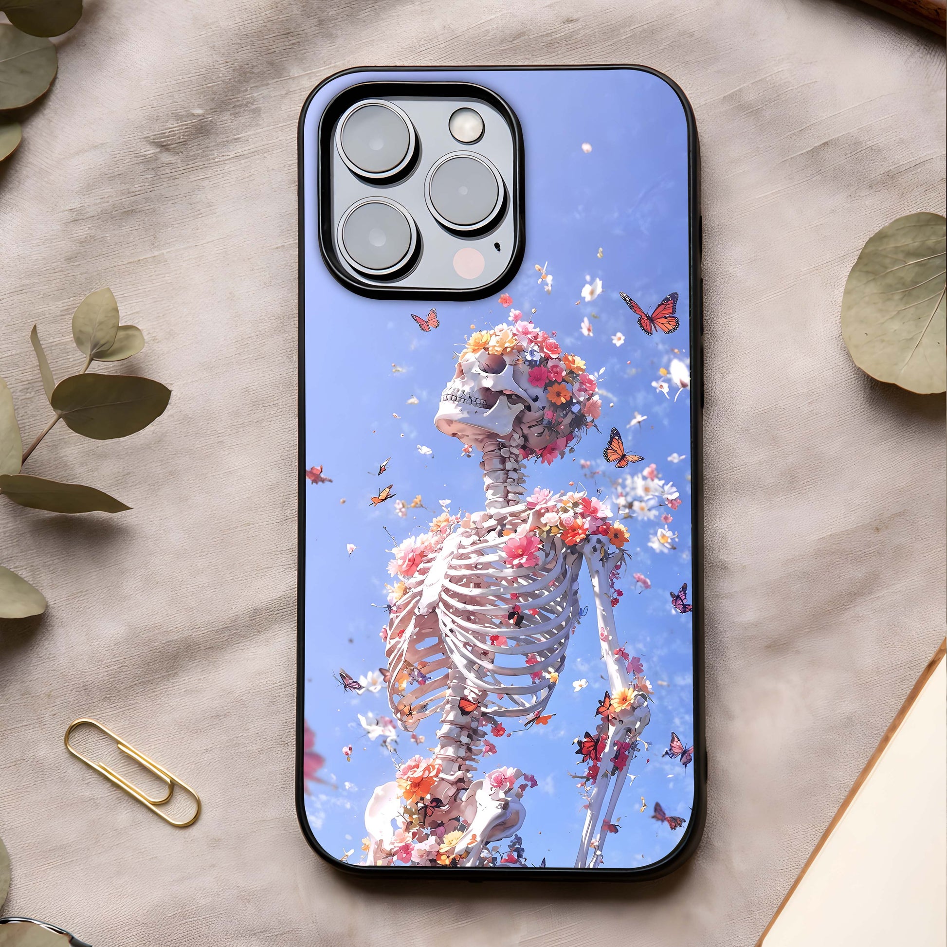 Bloom Beyond Bones Glass Case showing full back design in clean flat view with symbolic artwork and glossy glass finish.