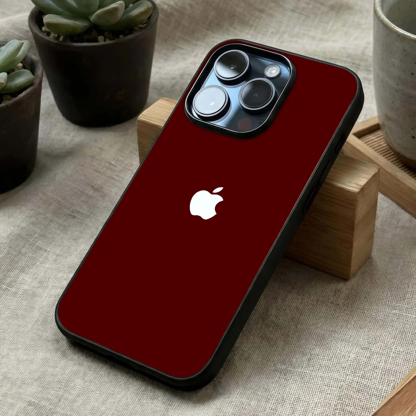 Apple Crimson Core Glass Case laid diagonally highlighting intense side tones and HD glass shine.