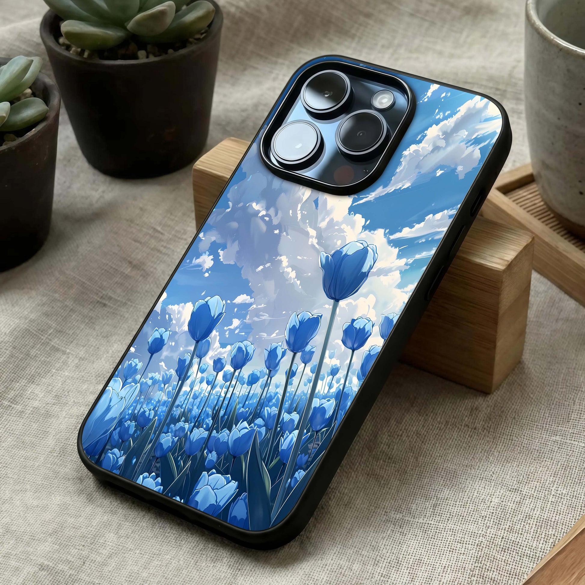 Blue Tulip Clouds Glass Case laid diagonally highlighting gentle blends and HD glass shine.