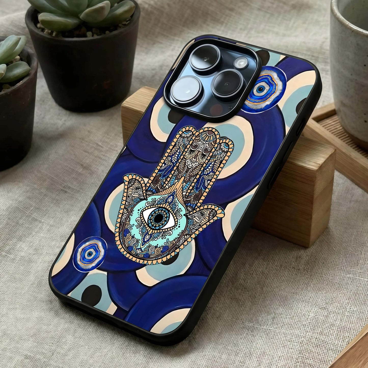 Hamsa Divine Guard Glass Case laid diagonally highlighting symbolic flow and HD glass shine.