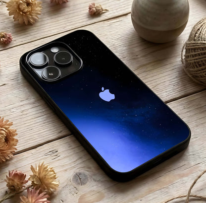 Cosmic Blue Apple Glass Case photographed in natural light showing reflective finish and cosmic depth.