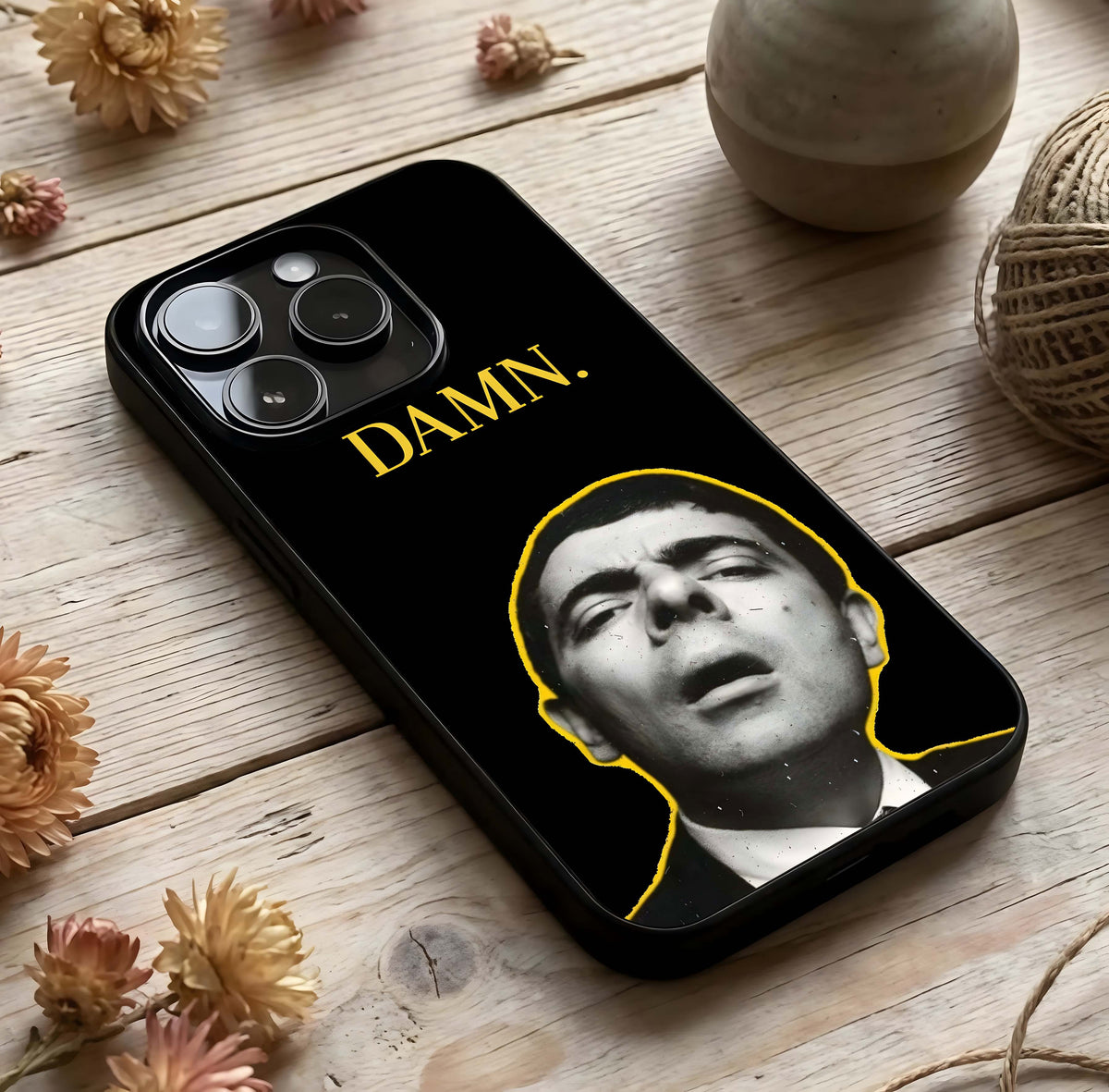 Mr Bean Damn Glass Case photographed in natural light showing reflective finish and quirky depth.