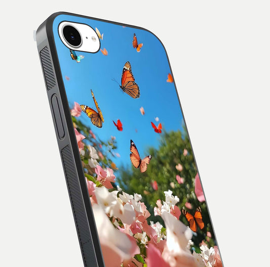 Butterflies in Bloom Sky Glass Case for iPhone 16e close-up shot showing wings, petal reflections, and soft hues