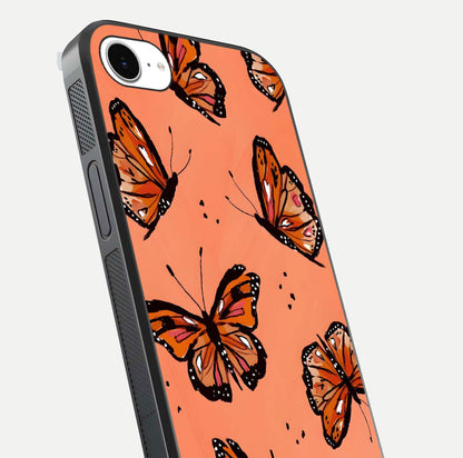 Coral Wing Butterfly Glass Case for iPhone 16e close-up highlighting wing pattern, coral tones, and reflection shine