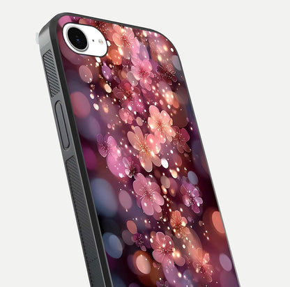 Glowing Petal Bliss Glass Case for iPhone 16e close-up angled shot showing petal glow, color depth, and reflection shine