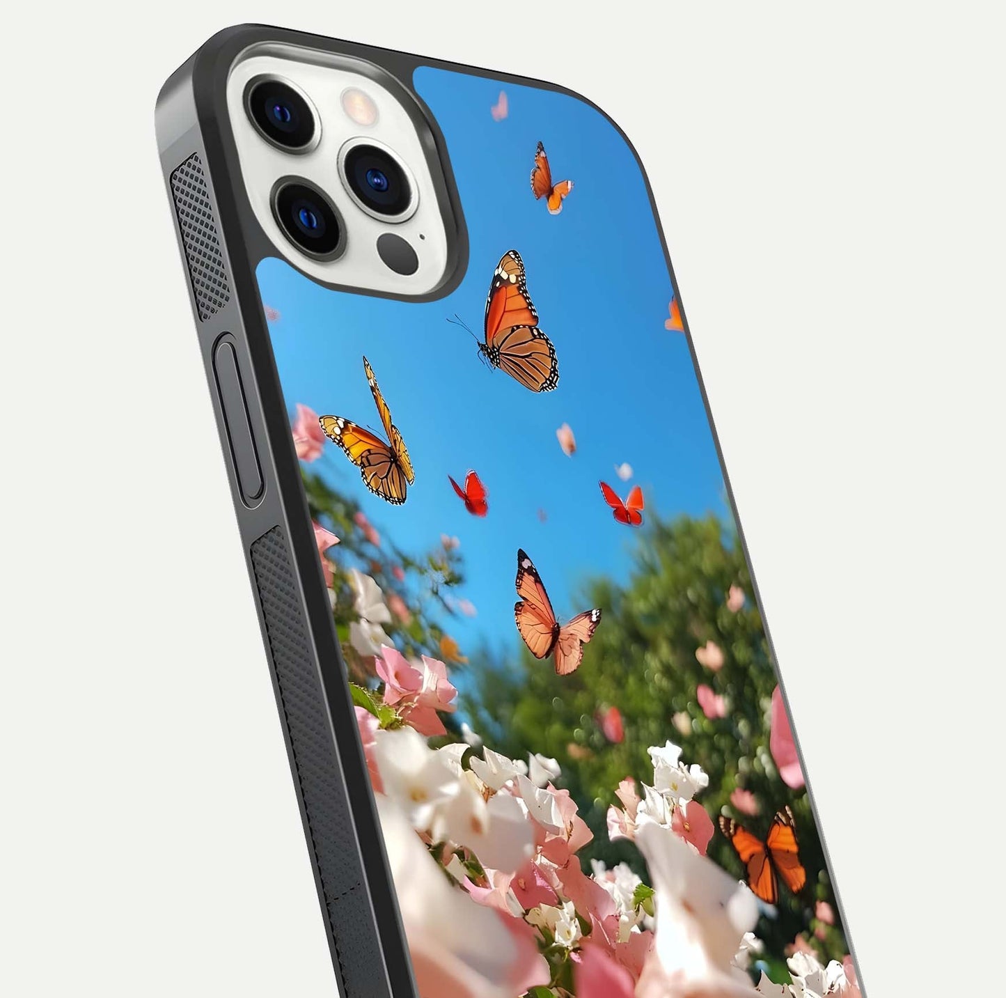 Butterflies in Bloom Sky Glass Case for iPhone 12 Pro close-up shot showing wings, petal reflections, and soft hues