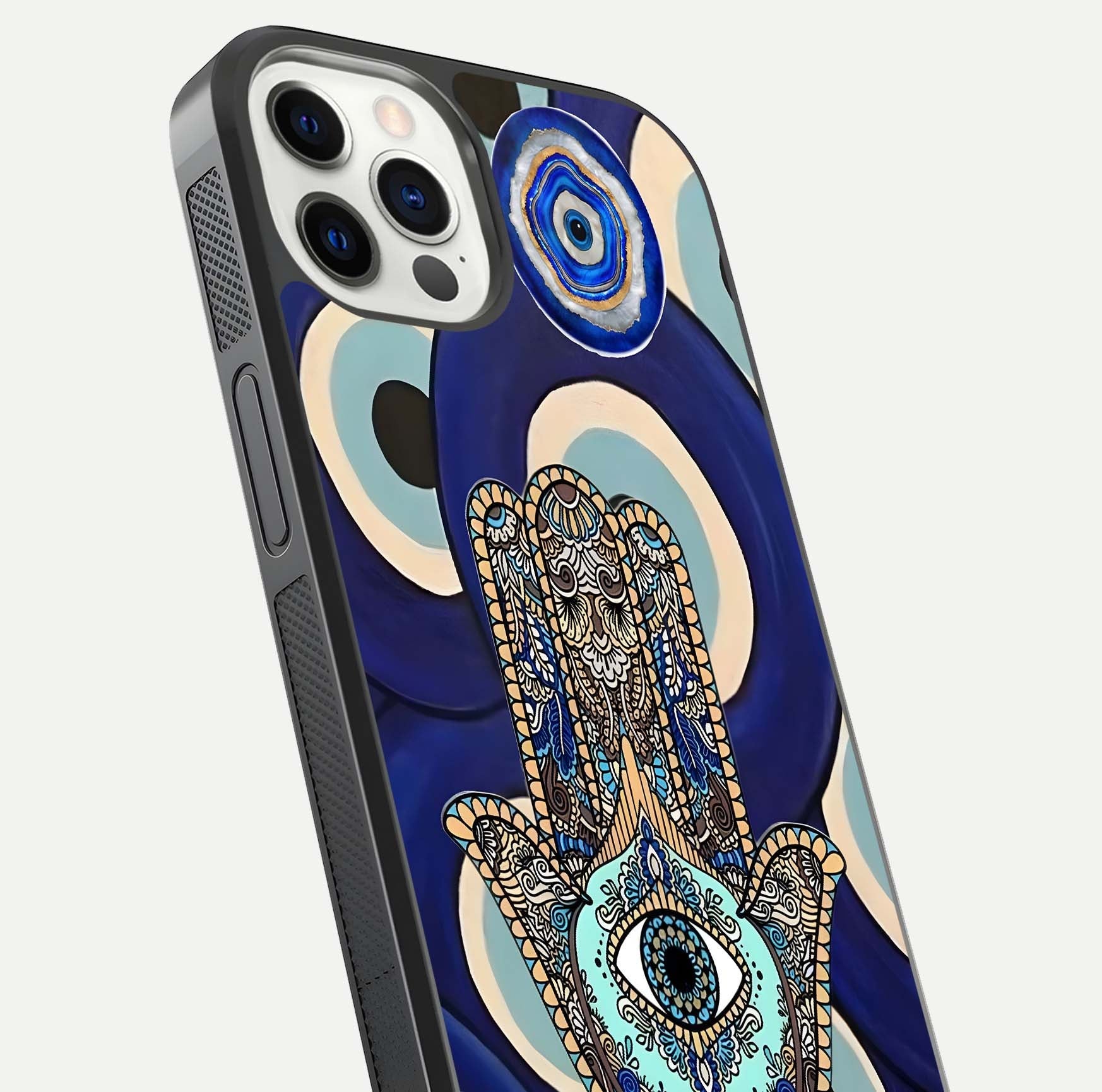 Hamsa Divine Guard Glass Case for iPhone 12 Pro close-up angled shot showing detailed palm motif and reflection glow