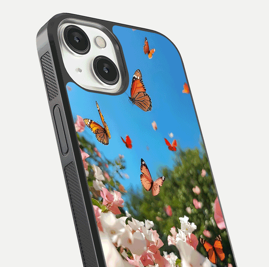 Butterflies in Bloom Sky Glass Case for iPhone 13 close-up shot showing wings, petal reflections, and soft hues