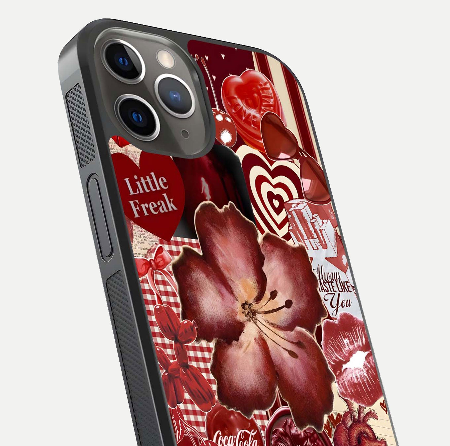 Aesthetic Little Freak Glass Case for iPhone 16 Pro close-up angled shot showing detailed artwork, bold design, and gloss reflection