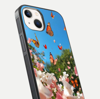 Butterflies in Bloom Sky Glass Case for iPhone 14 close-up shot showing wings, petal reflections, and soft hues