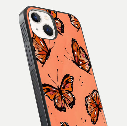 Coral Wing Butterfly Glass Case for iPhone 14 close-up highlighting wing pattern, coral tones, and reflection shine