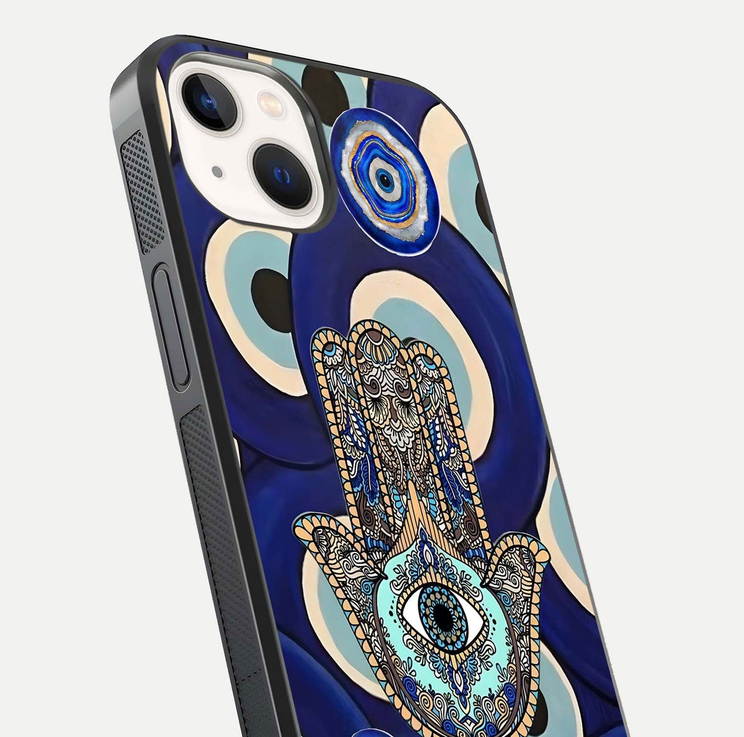 Hamsa Divine Guard Glass Case for iPhone 14 close-up angled shot showing detailed palm motif and reflection glow