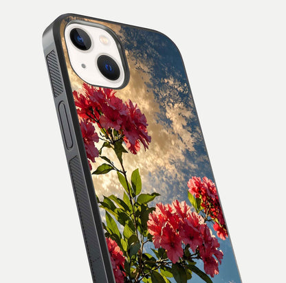 Red Bloom Skies Glass Case for iPhone 14 close-up angled shot highlighting detailed blooms and reflection
