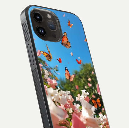 Butterflies in Bloom Sky Glass Case for iPhone 14 Pro Max close-up shot showing wings, petal reflections, and soft hues