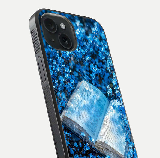 Blue Bloom Tales Glass Case for iPhone 15 close-up angle showing petal texture and blue tone reflection