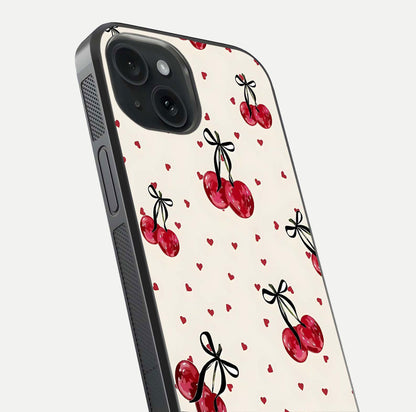 Cherry Heart Bow Glass Case for iPhone 15 close-up highlighting small bows, cherry red tones, and gloss shine