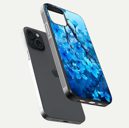 Blue Blossoms Branch Glass Case for iPhone 15 floating mockup showing shine, curved edges, and branch detailing