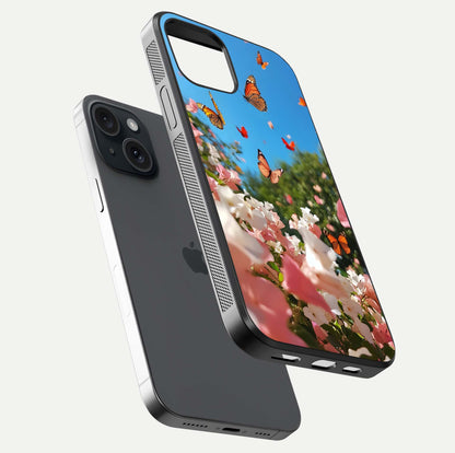 Butterflies in Bloom Sky Glass Case for iPhone 15 floating mockup capturing butterfly motion and edge design
